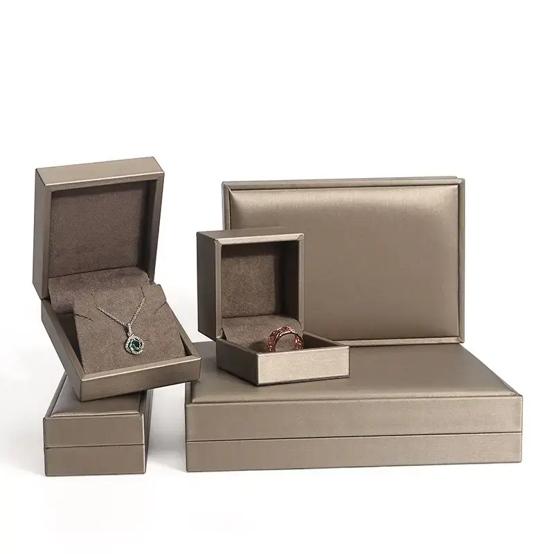 Custom brushed leather jewelry box with debossed logo and velvet interior, available in multiple brand colors