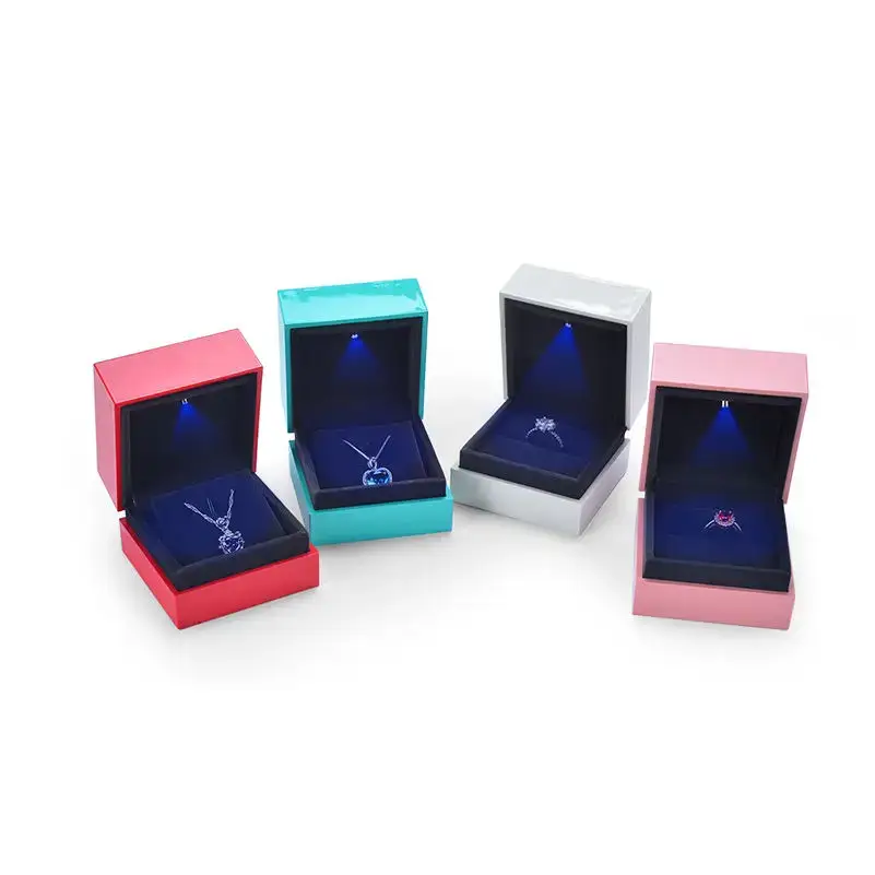 Custom luxury engagement ring box with integrated LED light, embossed logo branding, and velvet-lined insert display