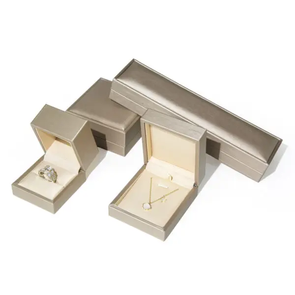 Gold foil custom leather ring box with soft suede interior lining and hinged lid for retail jewelry packaging