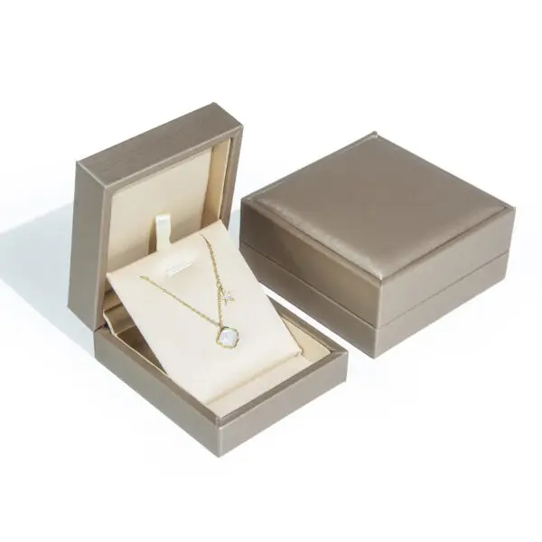 Gold foil custom leather ring box with soft suede interior lining and hinged lid for retail jewelry packaging