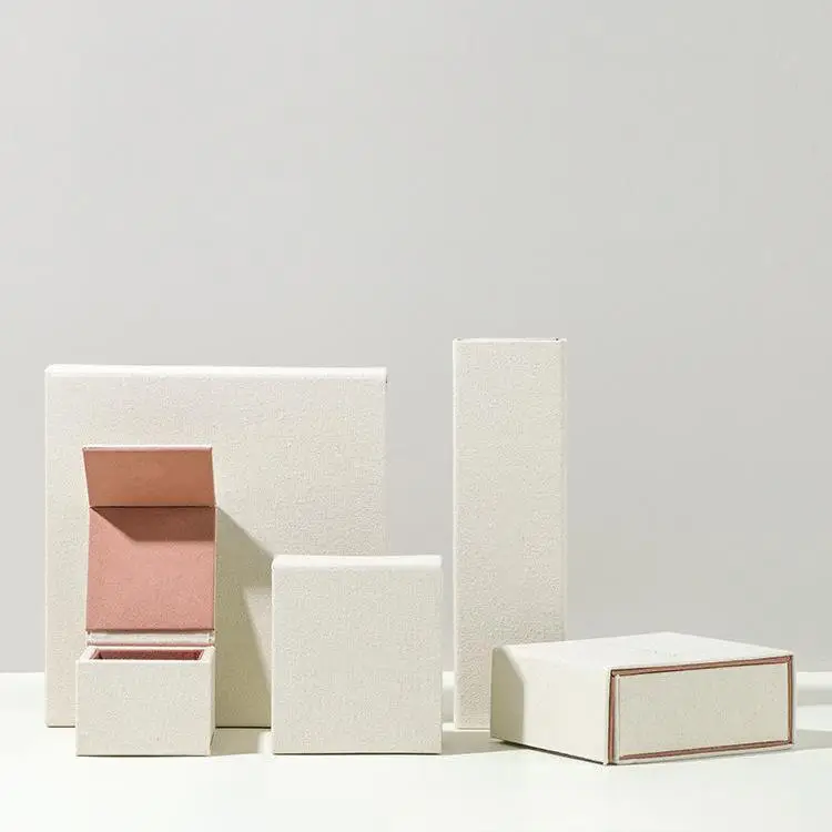 Luxury beige linen-cotton jewelry boxes with embossed logo and velvet-lined interior with foam ring holders