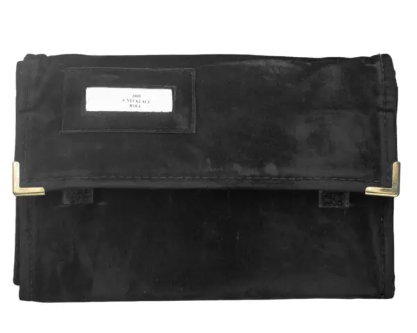 Custom jewelry travel roll with four snap closures for organizing and protecting necklaces during travel and transit.
