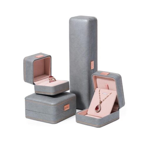 Custom grey leather earring boxes with personalized logo branding and foam insert lining for jewelry retail packaging