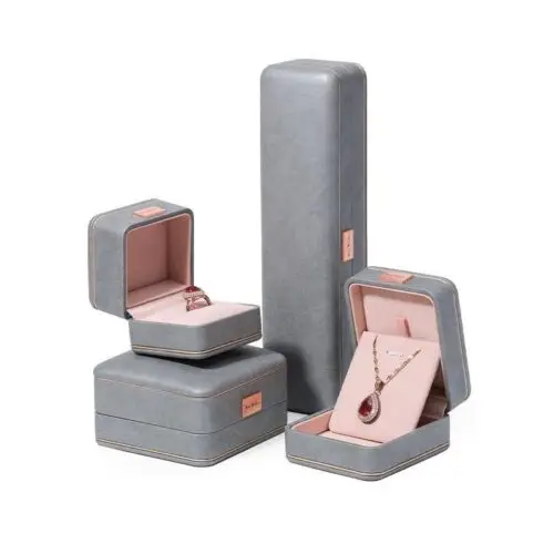 Custom grey leather earring boxes with personalized logo branding and foam insert lining for jewelry retail packaging