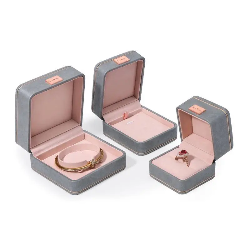 Custom grey leather earring boxes with personalized logo branding and foam insert lining for jewelry retail packaging