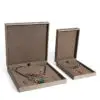Brushed leather jewelry box with custom embossed logo, premium interior lining, and customizable compartments for ring and pendant storage