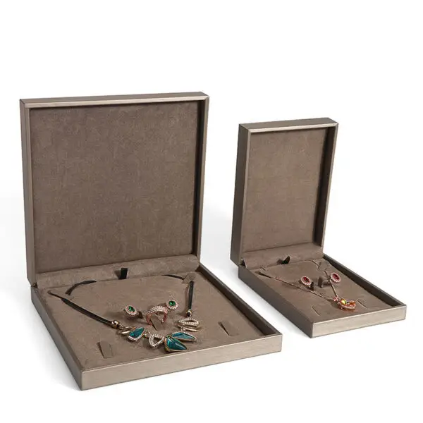 Brushed leather jewelry box with custom embossed logo, premium interior lining, and customizable compartments for ring and pendant storage