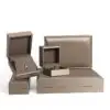 Brushed leather jewelry box with custom embossed logo, premium interior lining, and customizable compartments for ring and pendant storage