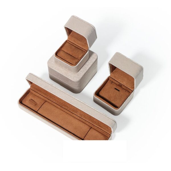 Premium gray leather flip-top jewelry box with custom logo branding, luxury retail packaging