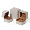 Premium gray leather flip-top jewelry box with custom logo branding, luxury retail packaging