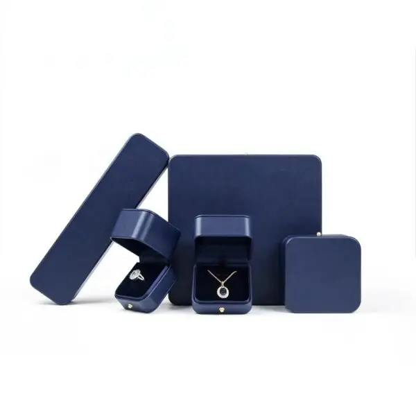 Custom leather jewelry box with earring insert, ring display compartment, and branded closure