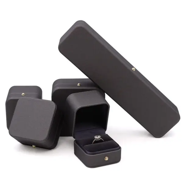 Custom leather jewelry box with earring insert, ring display compartment, and branded closure
