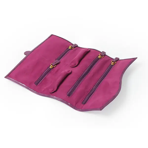Custom purple leather jewelry roll bag with personalized branding and interior pockets for traveling jewelry organization