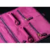 Custom purple leather jewelry roll bag with personalized branding and interior pockets for traveling jewelry organization