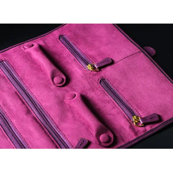 Custom purple leather jewelry roll bag with personalized branding and interior pockets for traveling jewelry organization