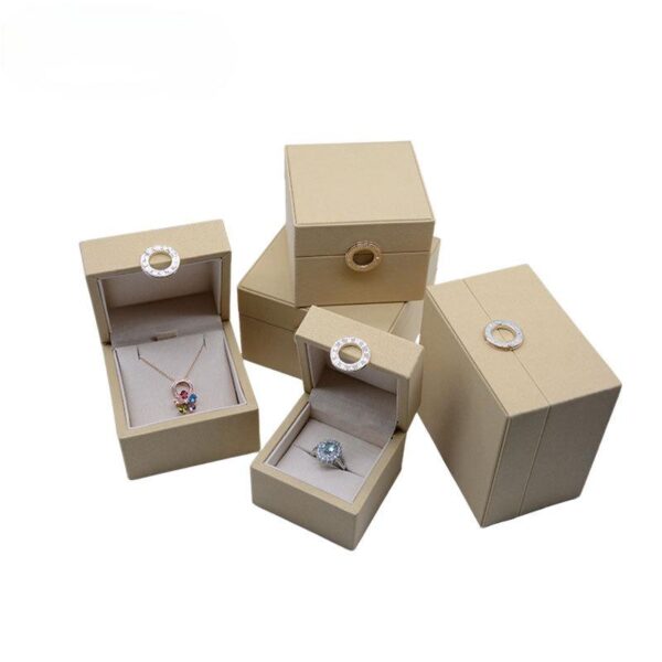 Custom leather ring box with gold hot-stamped logo and velvet interior