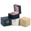 Custom leather ring box with gold hot-stamped logo and velvet interior