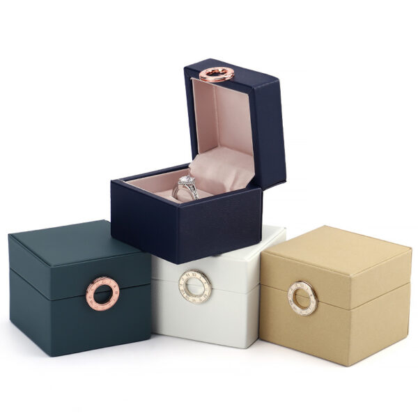 Custom leather ring box with gold hot-stamped logo and velvet interior