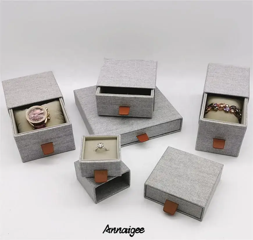 Custom linen fabric sliding drawer earring box with velvet insert and gold hot-foil logo branding for jewelry brands