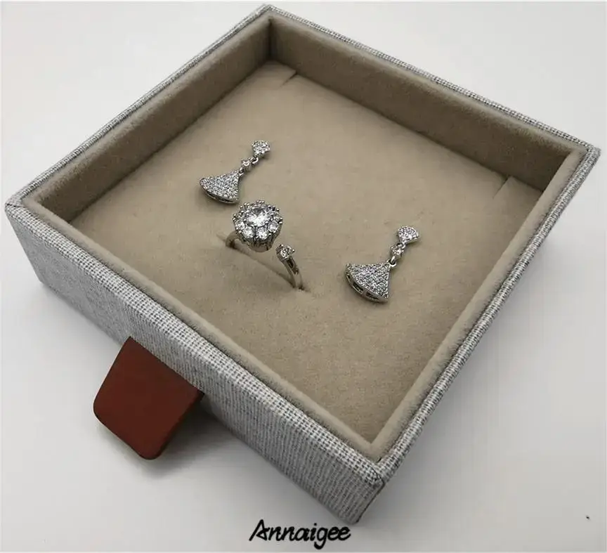 Linen fabric sliding drawer jewelry box with compartmented interior for earrings, rings, bracelets, and necklaces