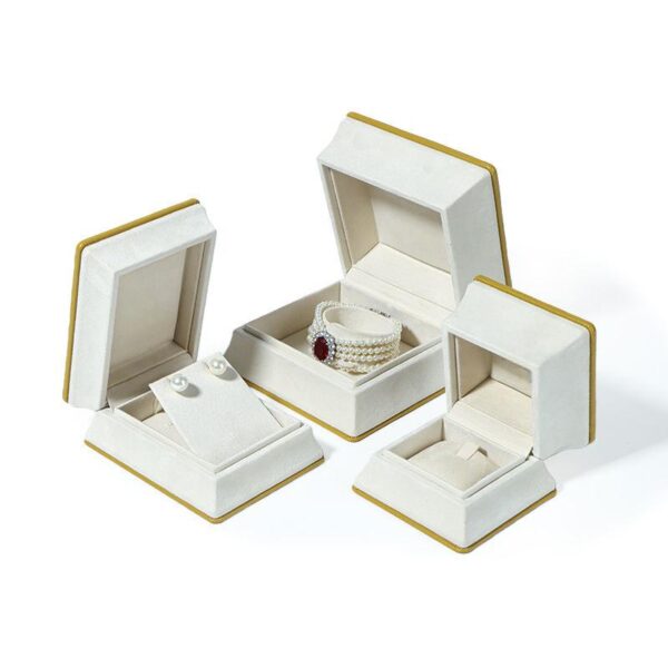 Luxury rigid jewelry box with ornate Middle Eastern-inspired design in deep jewel tones with gold accents, custom branded