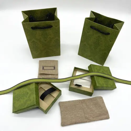 Premium custom luxury paper jewelry box with matching fabric pouch, hot-stamped logo, and coordinated branding.