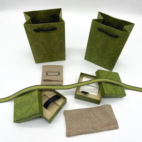 Premium custom luxury paper jewelry box with matching fabric pouch, hot-stamped logo, and coordinated branding.