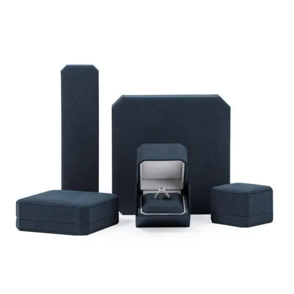 Custom navy blue velvet jewelry box with logo embossing and silk insert, wholesale luxury packaging for jewelry brands