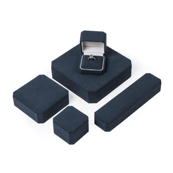 Custom navy blue velvet jewelry box with logo embossing and silk insert, wholesale luxury packaging for jewelry brands
