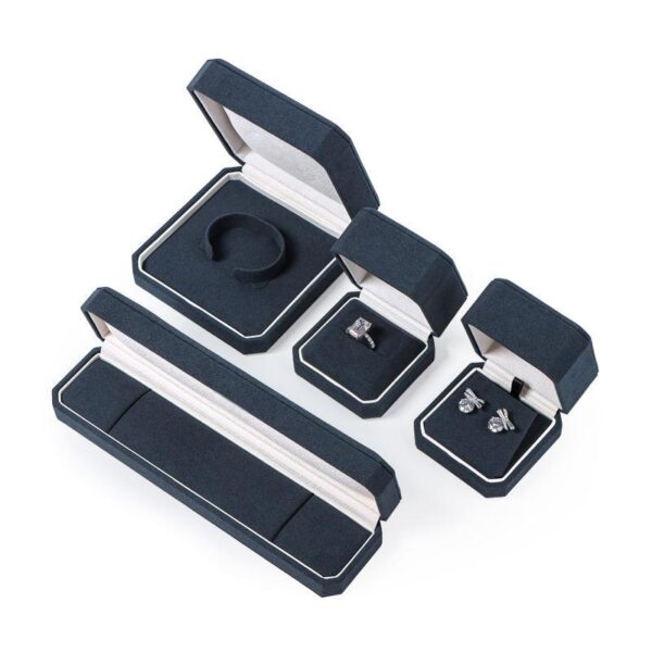 Custom navy blue velvet jewelry box with logo embossing and silk insert, wholesale luxury packaging for jewelry brands