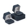 Custom navy blue velvet jewelry box with logo embossing and silk insert, wholesale luxury packaging for jewelry brands