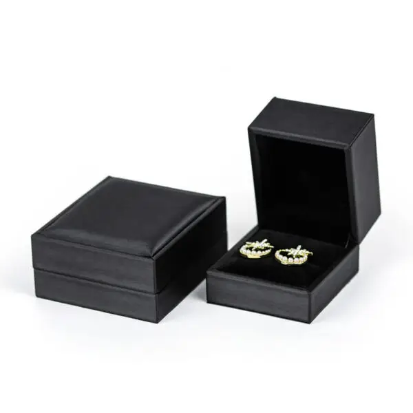 Custom PU leather jewelry box with silk interior and embossed logo branding for luxury wholesale jewelry packaging