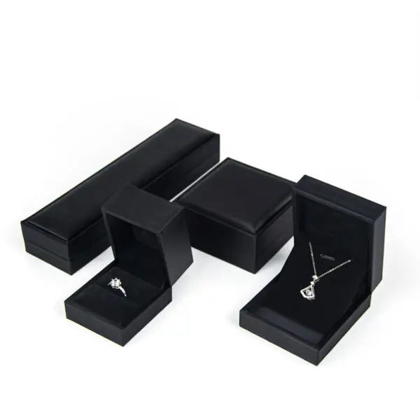 Custom PU leather jewelry box with silk interior and embossed logo branding for luxury wholesale jewelry packaging