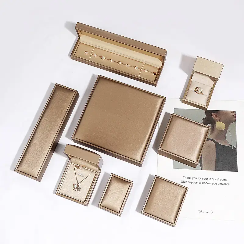 Custom PU leather jewelry box with embossed logo and microfiber insert for rings, earrings, and bracelets—premium packaging for jewelry brands