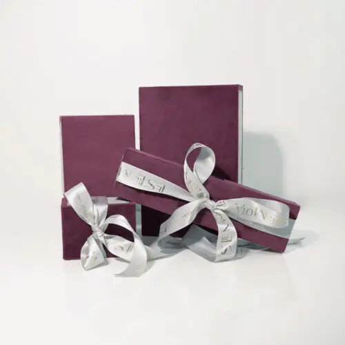 Custom luxury ribbon drawer jewelry box with protective foam insert and branded closure, shown open