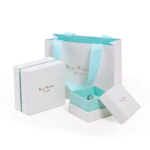 Custom two-piece rigid gift box with integrated handbag handles, featuring premium branding and custom foam insert