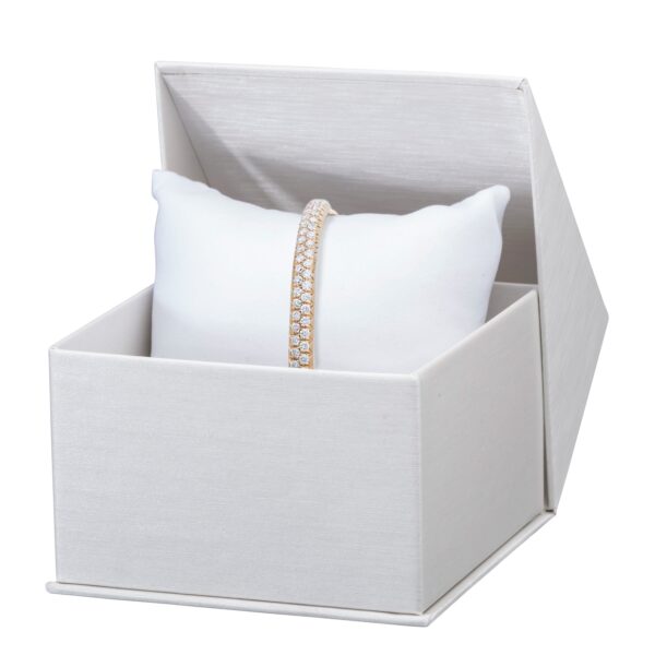 Custom silk-brushed paper pillow boxes with gold foil logo branding and velvet interior insert for jewelry display