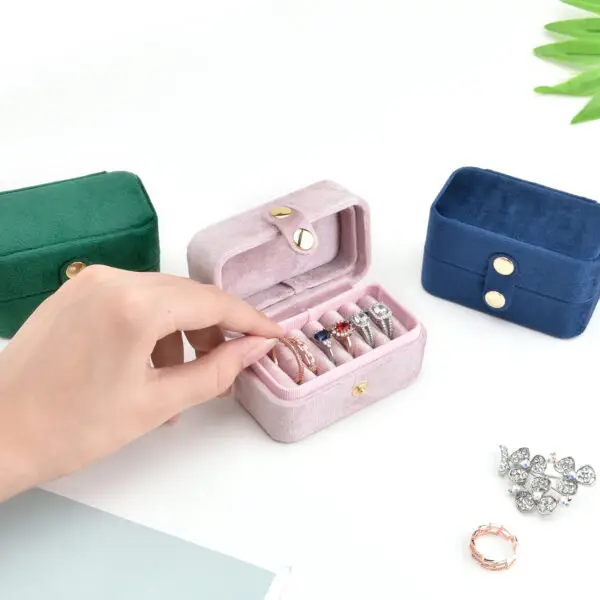 Luxury velvet travel ring storage box with custom logo branding and compartmentalized design