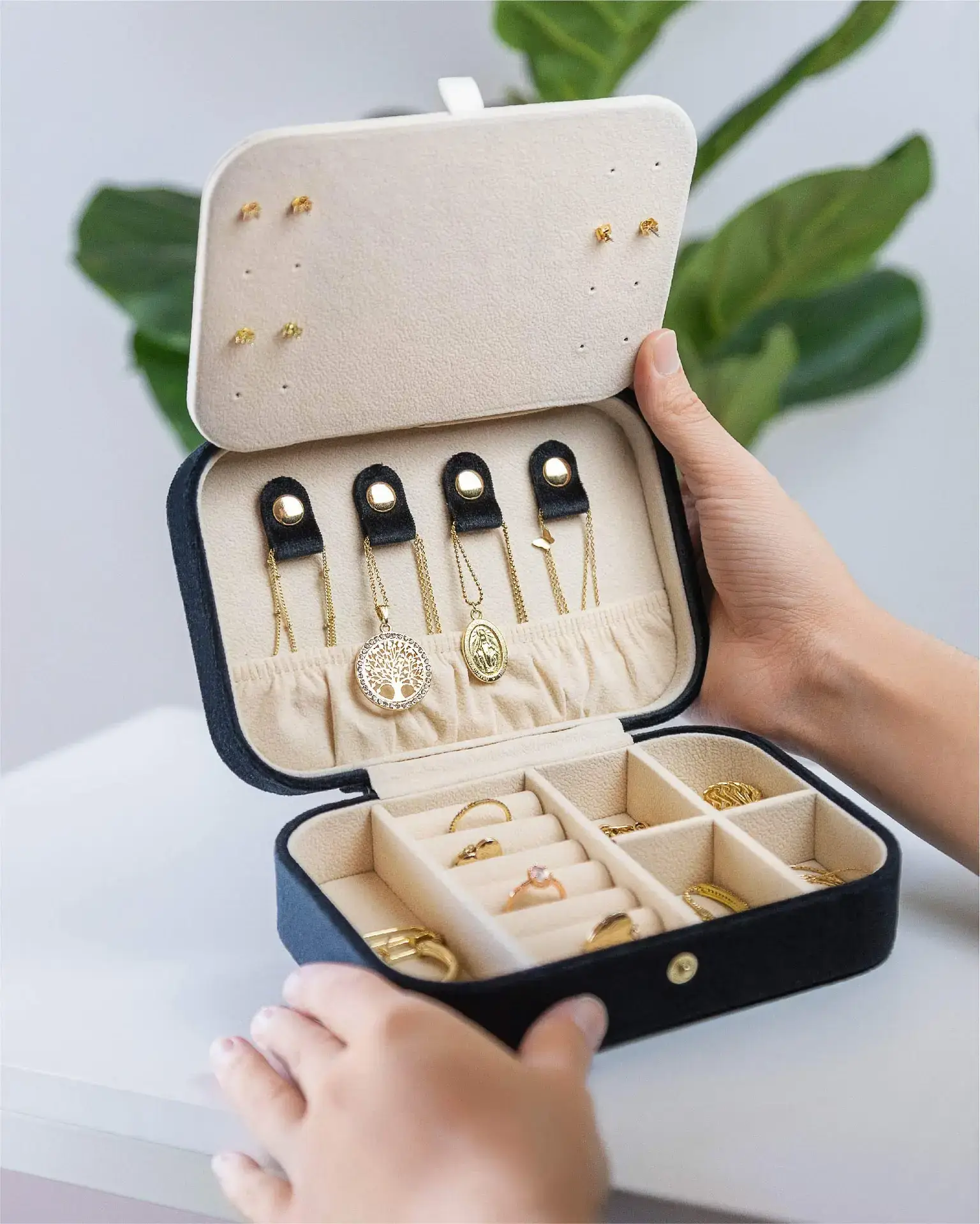 Custom velvet jewelry organizer case with mirror open, showing necklace hooks, ring rolls, and earring compartments