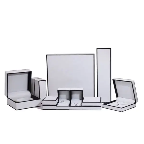 Custom white paperboard jewelry box with black border accent and protective foam insert