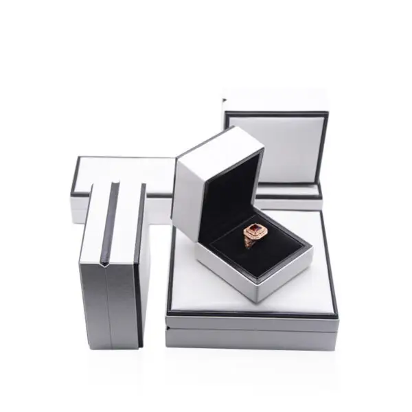 Custom white paperboard jewelry box with black border accent and protective foam insert