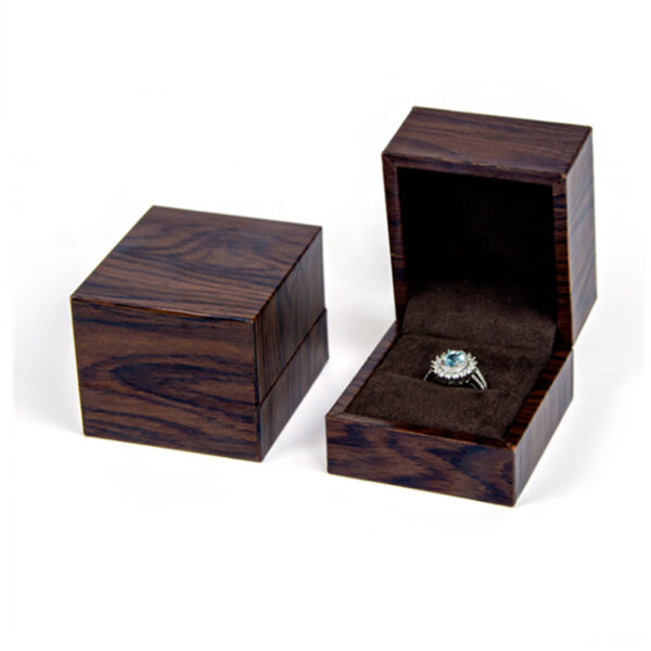Premium custom wooden ring box with velvet insert and personalized logo branding for jewelry retail packaging.
