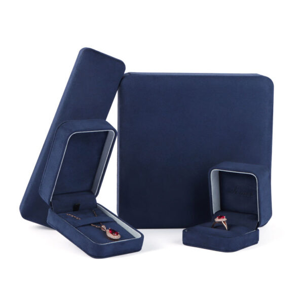 Navy blue velvet earring boxes with custom foam inserts and gold-embossed logo – premium jewelry packaging