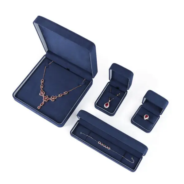 Navy blue velvet earring boxes with custom foam inserts and gold-embossed logo – premium jewelry packaging