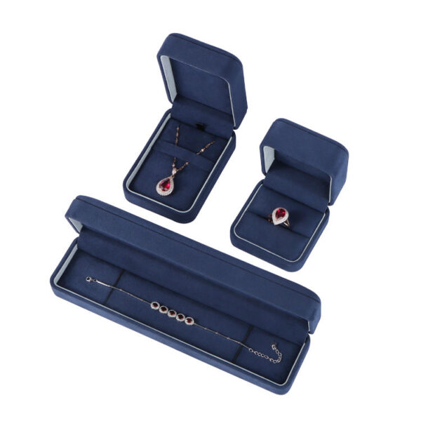 Navy blue velvet earring boxes with custom foam inserts and gold-embossed logo – premium jewelry packaging